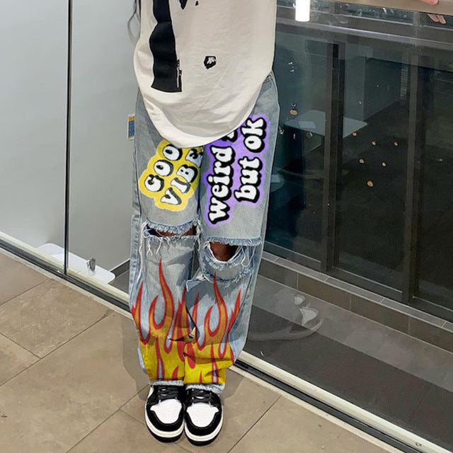 High-waisted printed denim pants with smiling faces