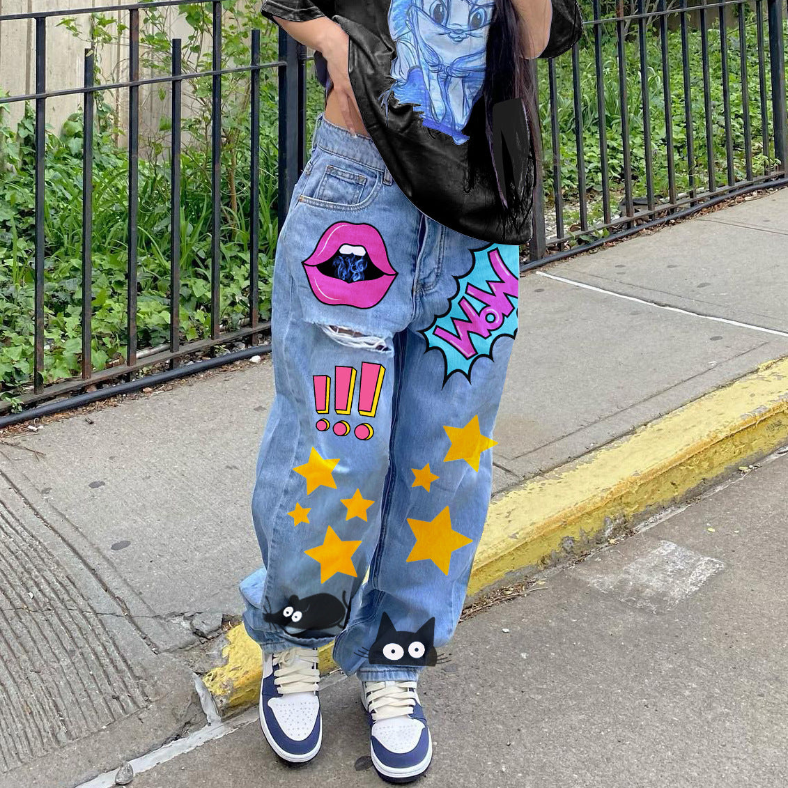 High-waisted printed denim pants with smiling faces