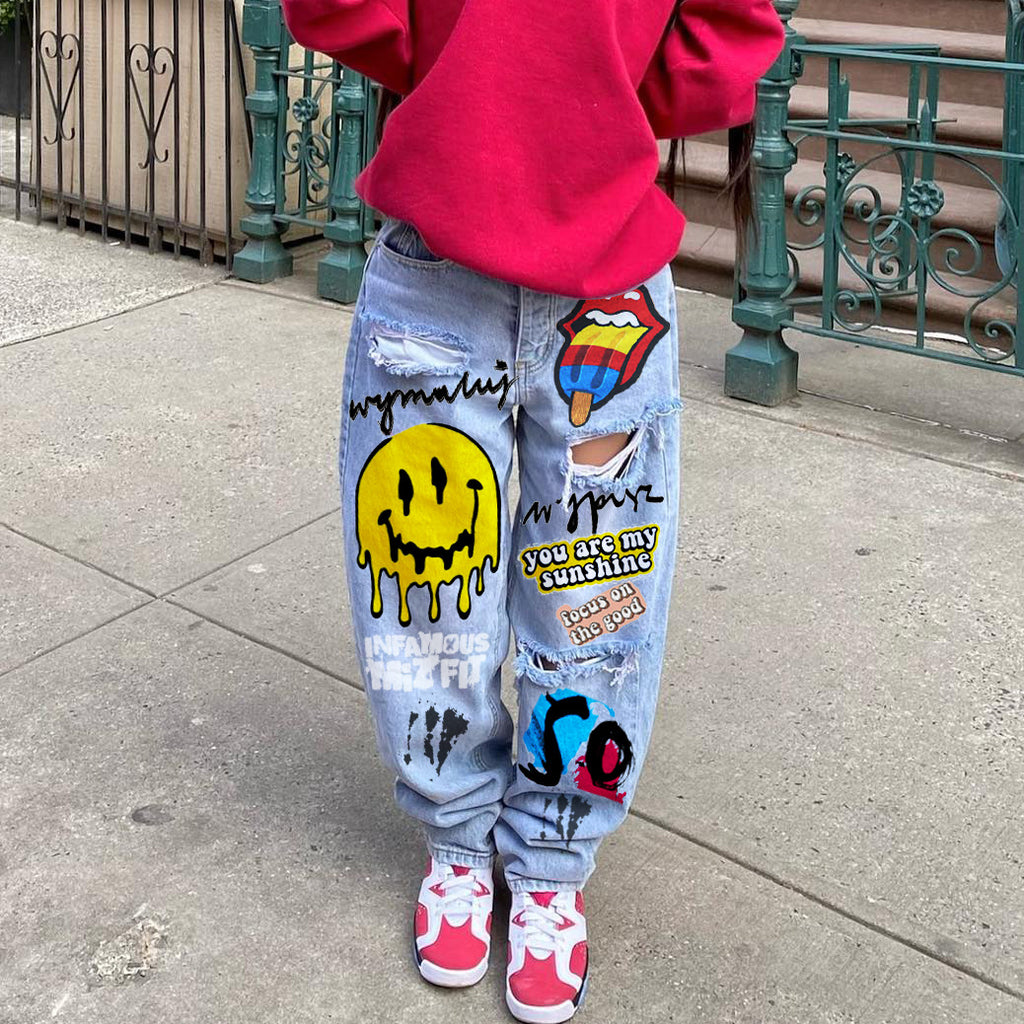 High-waisted printed denim pants with smiling faces