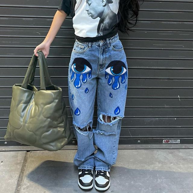 High-waisted printed denim pants with smiling faces